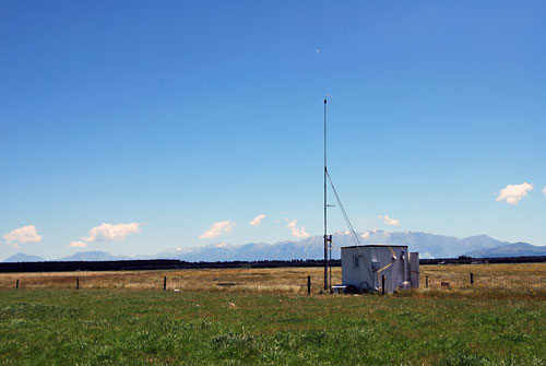 hut and mast in a field