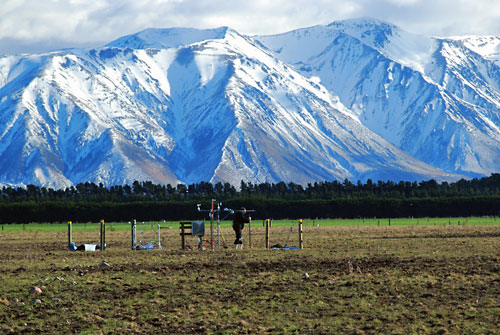 equipment in foreground, snowed covered mountians in background