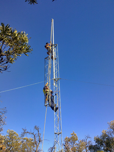 man attaching tower section